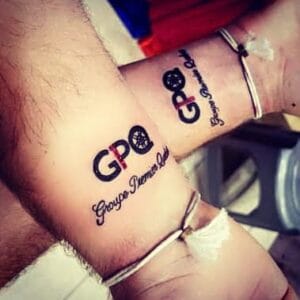 Tattoos on forearms of Groupe Premier Quebec (GPQ) logo